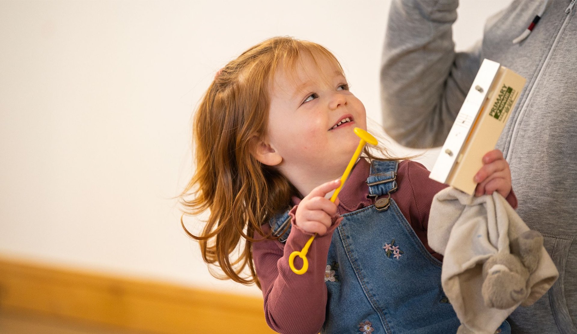 Child playing chimes at a Rhythm Time class