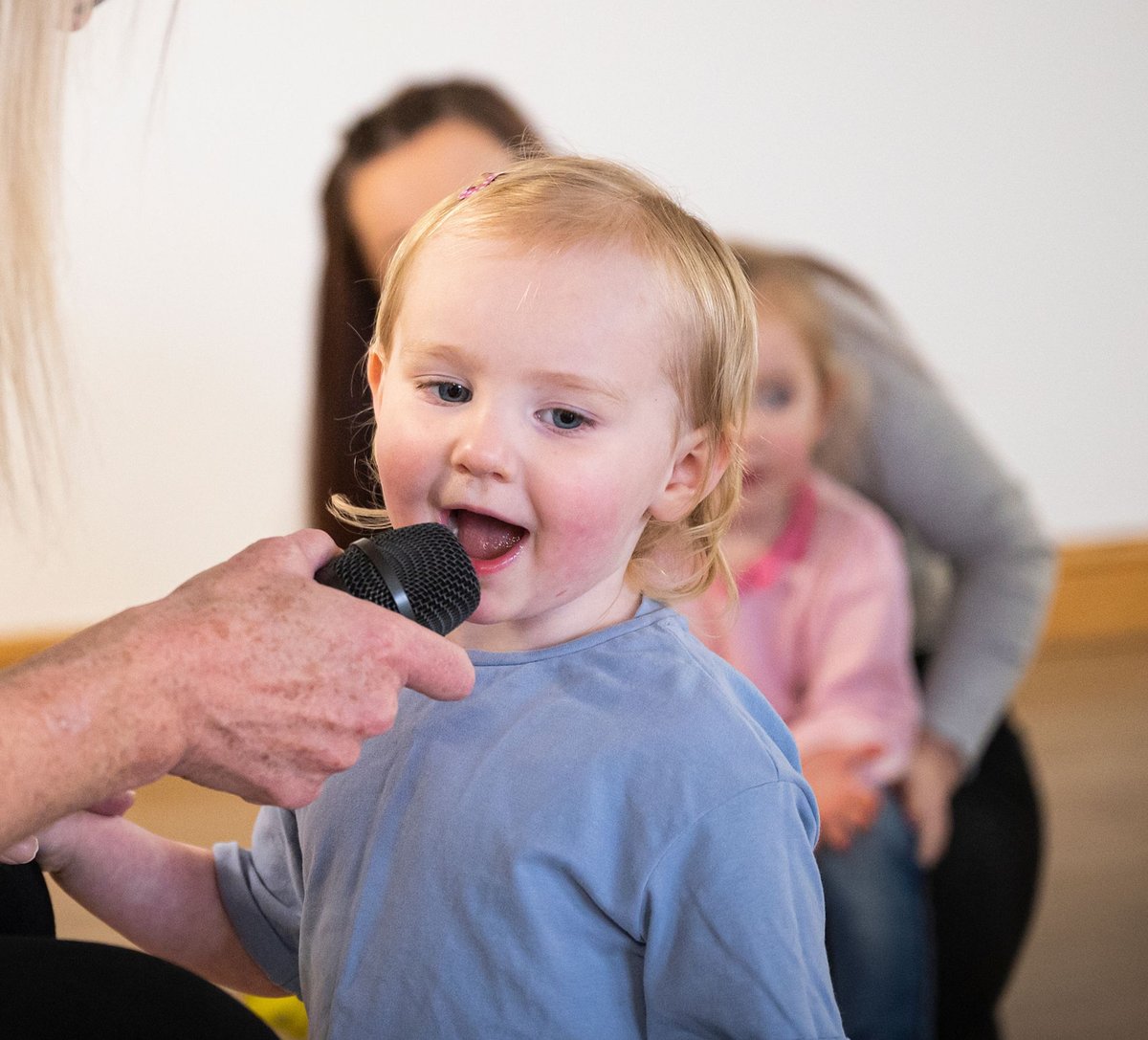 Young girl singing into a microphone at a Rhythm Time class